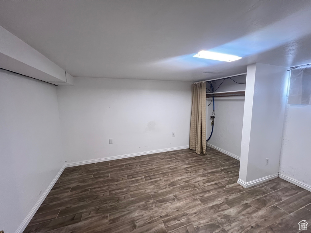 Finished basement with wood finished floors and baseboards
