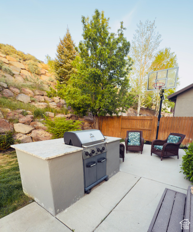 View of patio / terrace with an outdoor kitchen, a fenced backyard, and outdoor lounge area