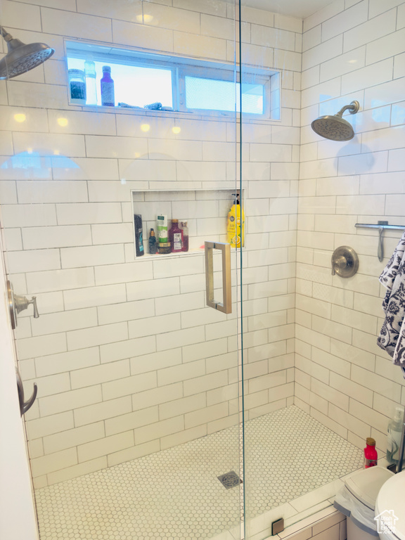 Full bath with a shower stall and toilet