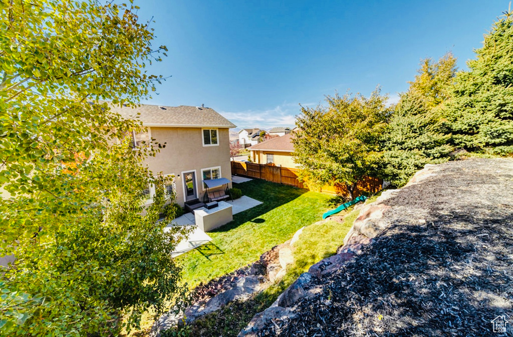 Rear view of house featuring stucco siding and a patio