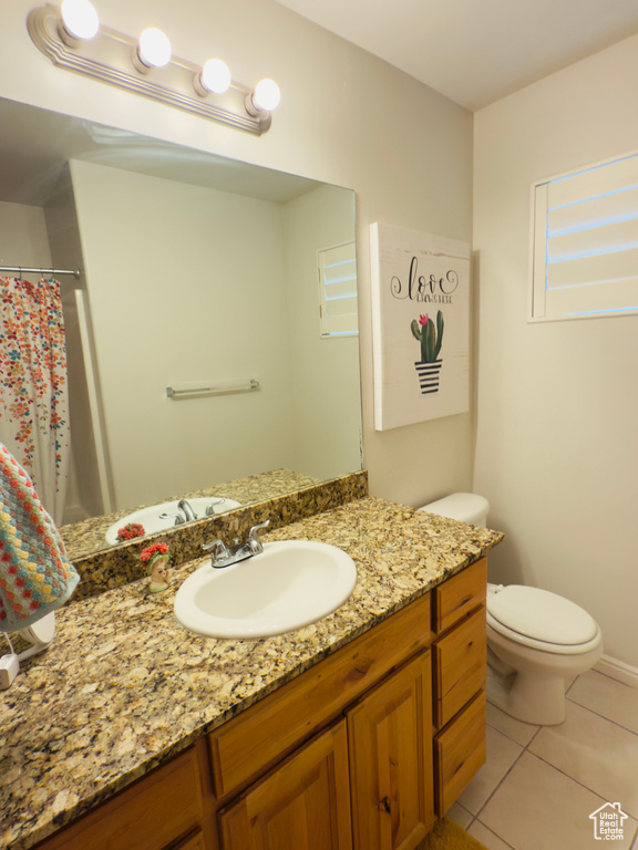 Full bathroom featuring tile patterned flooring, vanity, and toilet