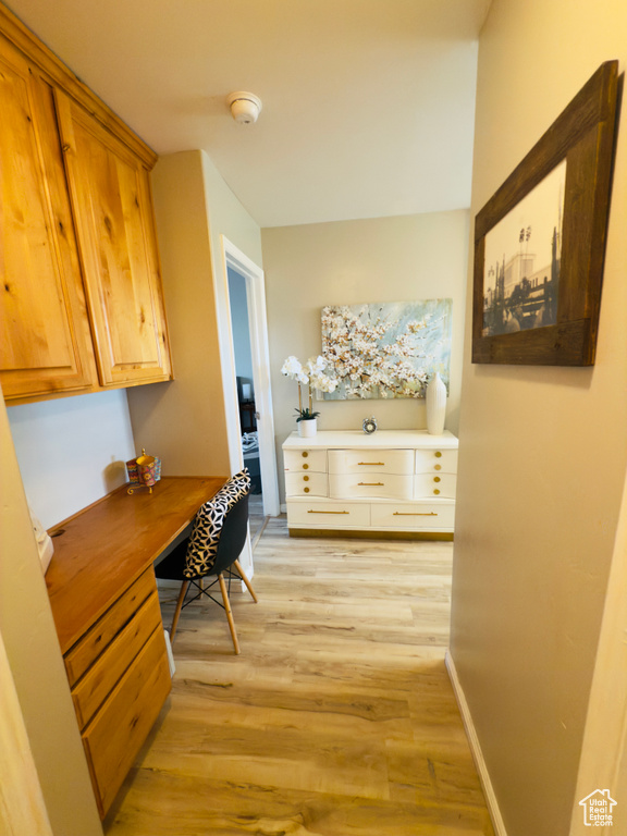 Hall with light wood-style flooring and an office area