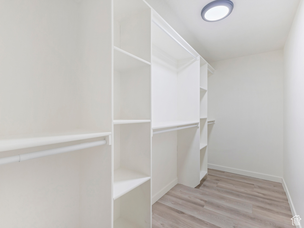 Walk in closet featuring light wood-style flooring