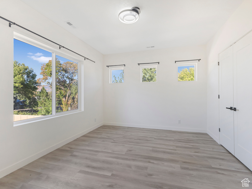 Unfurnished room featuring baseboards and light wood-style floors
