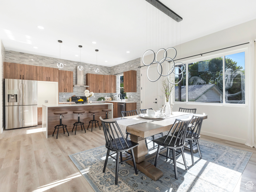 Dining space with recessed lighting, light wood-style flooring, and baseboards