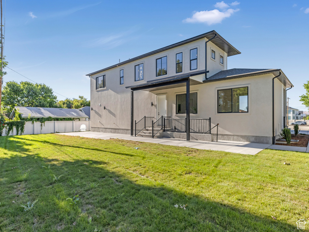 Rear view of house featuring a patio area and stucco siding