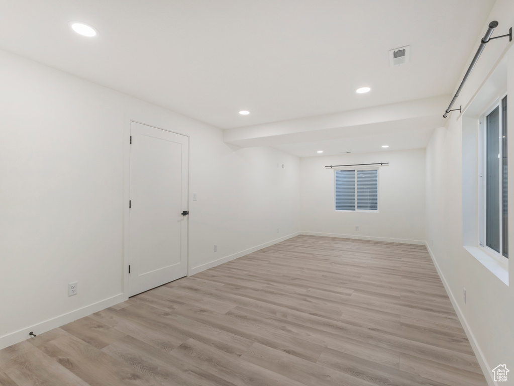 Unfurnished room with recessed lighting, light wood-style flooring, and baseboards