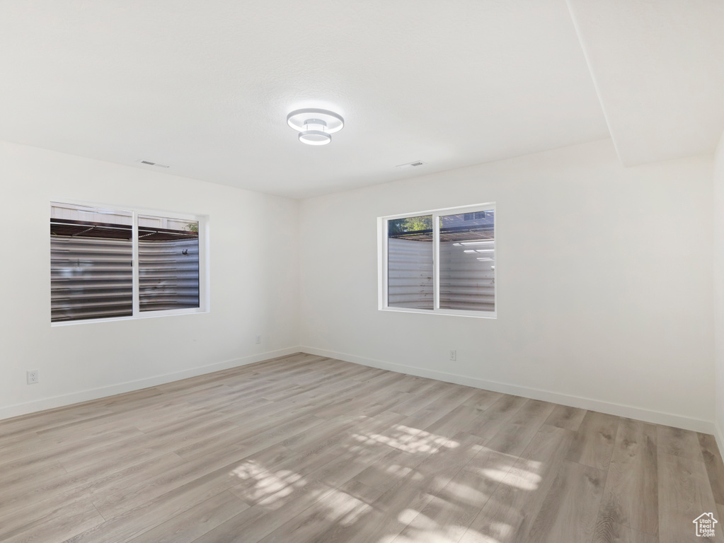 Spare room with light wood finished floors and baseboards