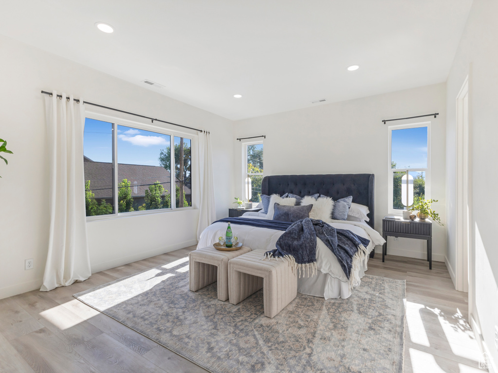 Bedroom featuring wood finished floors, recessed lighting, and baseboards