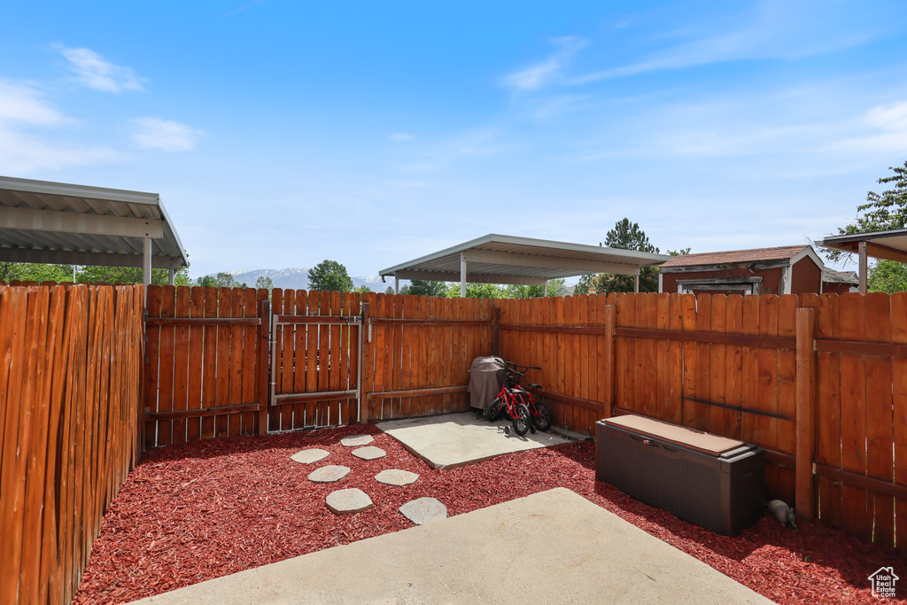 View of patio featuring fence and a gate