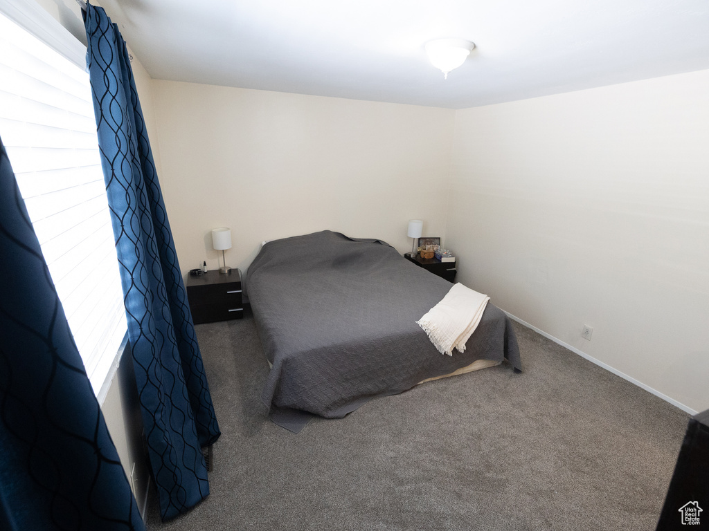 Carpeted bedroom featuring baseboards