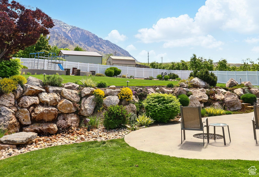 View of yard featuring a mountain view and a patio