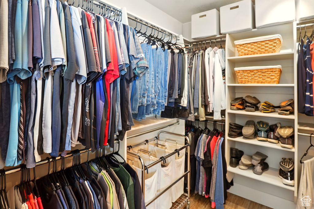 Walk in closet with wood finished floors