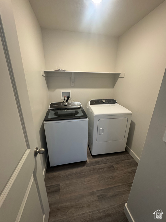 Laundry area with washing machine and clothes dryer and dark wood finished floors