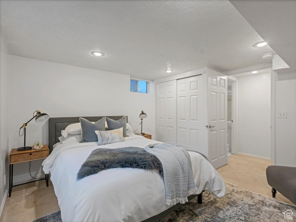 Carpeted bedroom featuring recessed lighting, a closet, and baseboards
