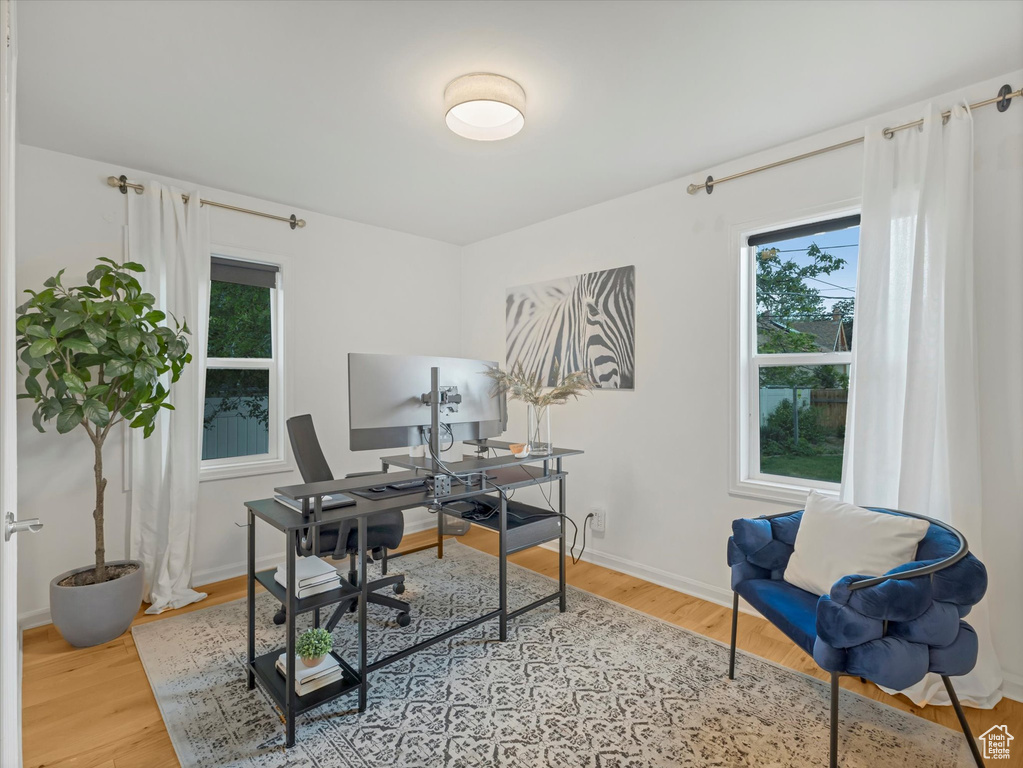 Home office with wood finished floors and baseboards
