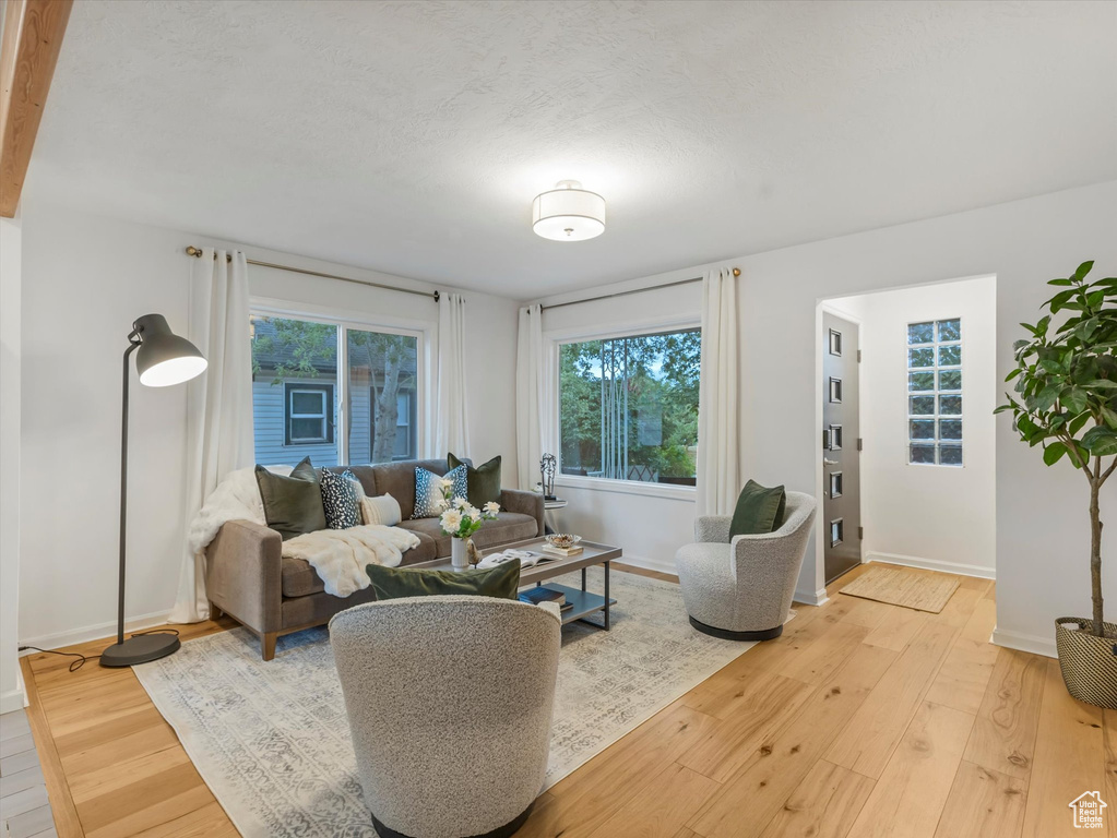 Living area with light wood-style flooring and baseboards