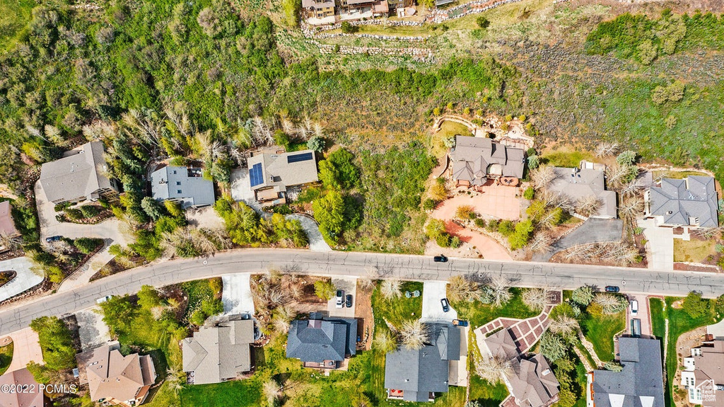 Aerial view of property and surrounding area with nearby suburban area