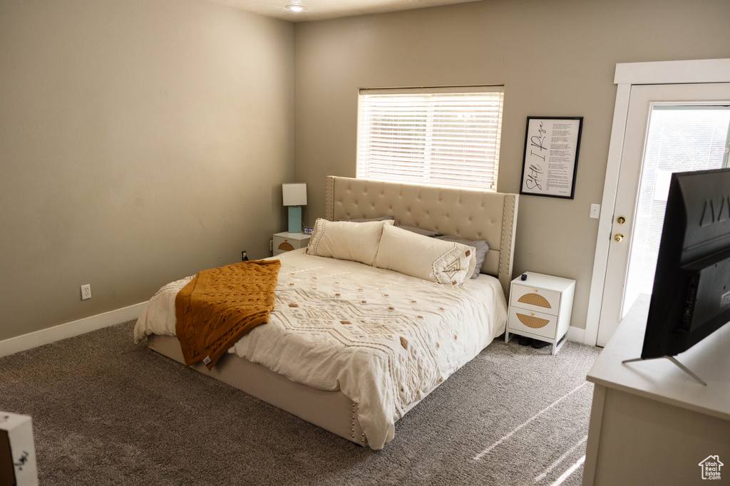 Carpeted bedroom featuring baseboards