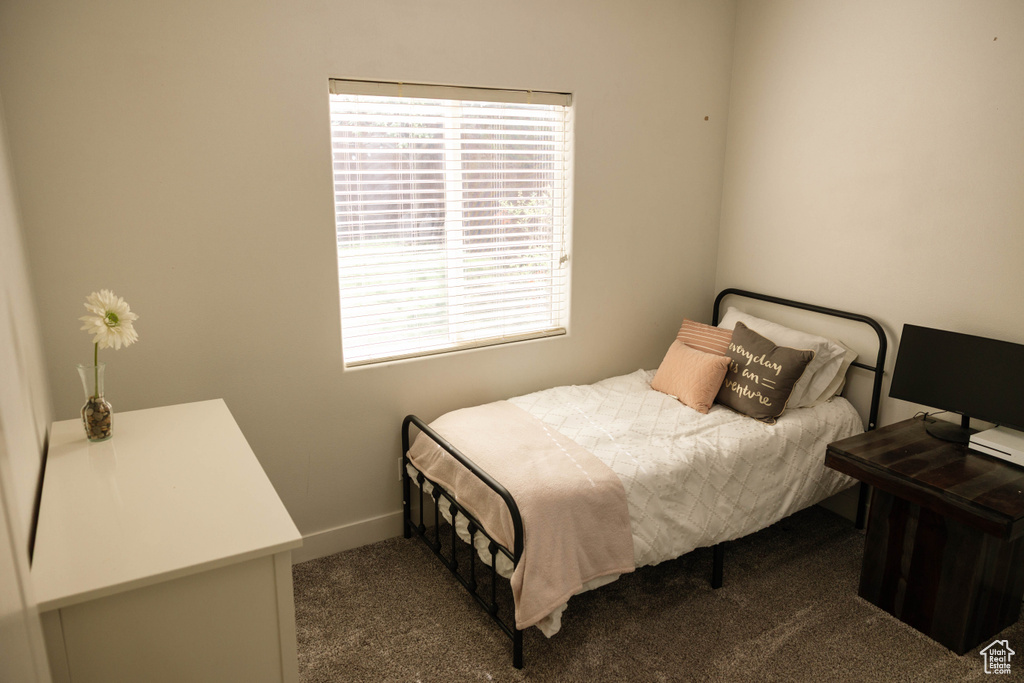 Bedroom featuring carpet flooring and baseboards