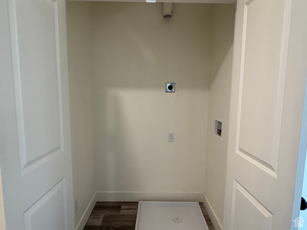 Clothes washing area featuring baseboards, washer hookup, dark wood-type flooring, and electric dryer hookup