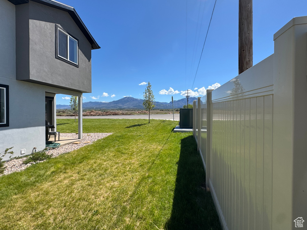 View of green lawn with a mountain view