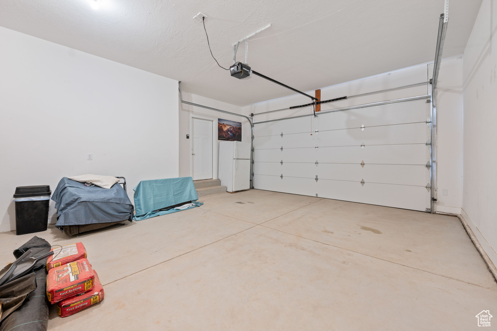 Garage featuring a garage door opener