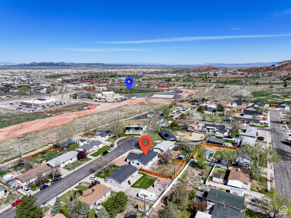 Aerial overview of property's location with mountains and nearby suburban area