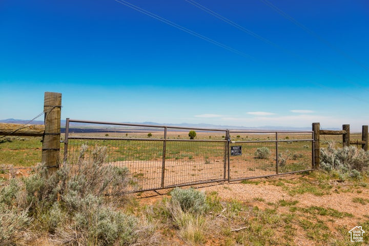 View of yard with fence, a view of countryside, a mountain view, and a gate