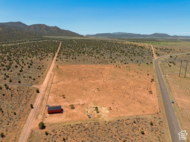 Aerial view of property's location featuring mountains, rural landscape, and a desert landscape