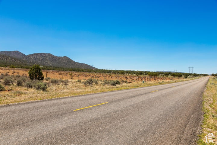 View of asphalt street featuring a mountain view and a view of countryside