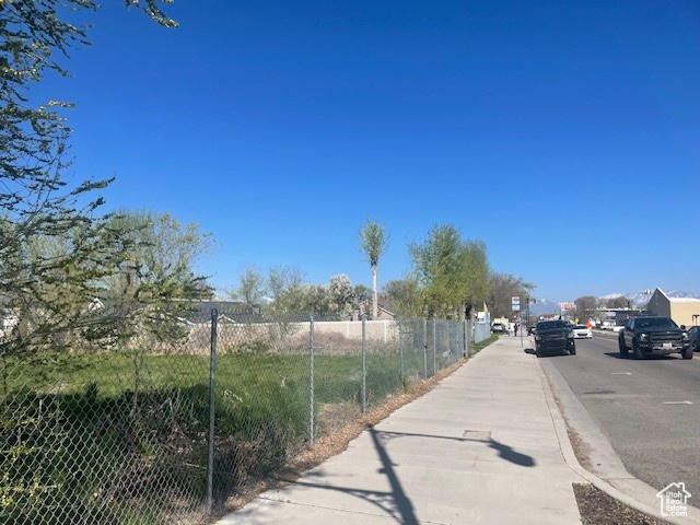 View of asphalt road with sidewalks and curbs