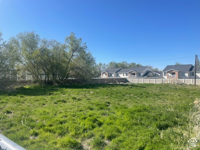 View of yard featuring fence