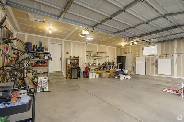 Garage with a garage door opener and a workshop area