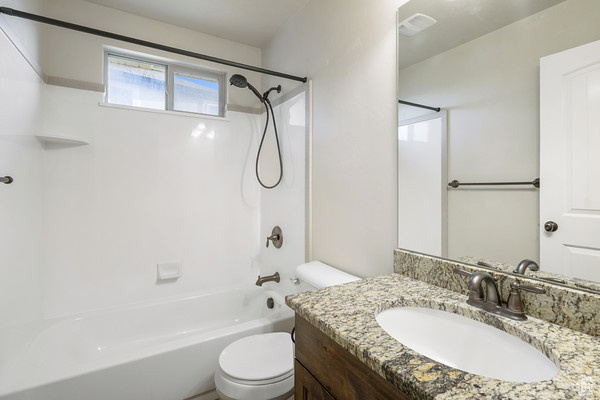 Full bath with toilet, shower / bathtub combination, and vanity