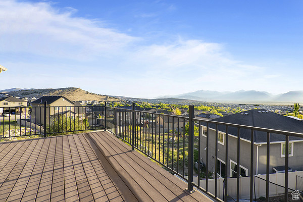 Wooden terrace featuring a mountain view and a residential view