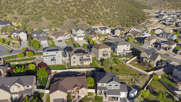 Aerial view of property\\\'s location featuring nearby suburban area and a mountain backdrop