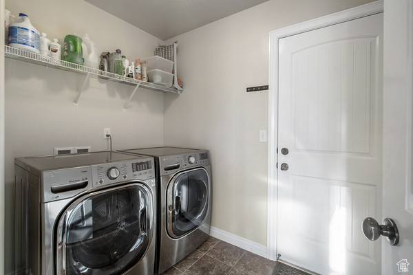 Laundry room featuring independent washer and dryer and baseboards
