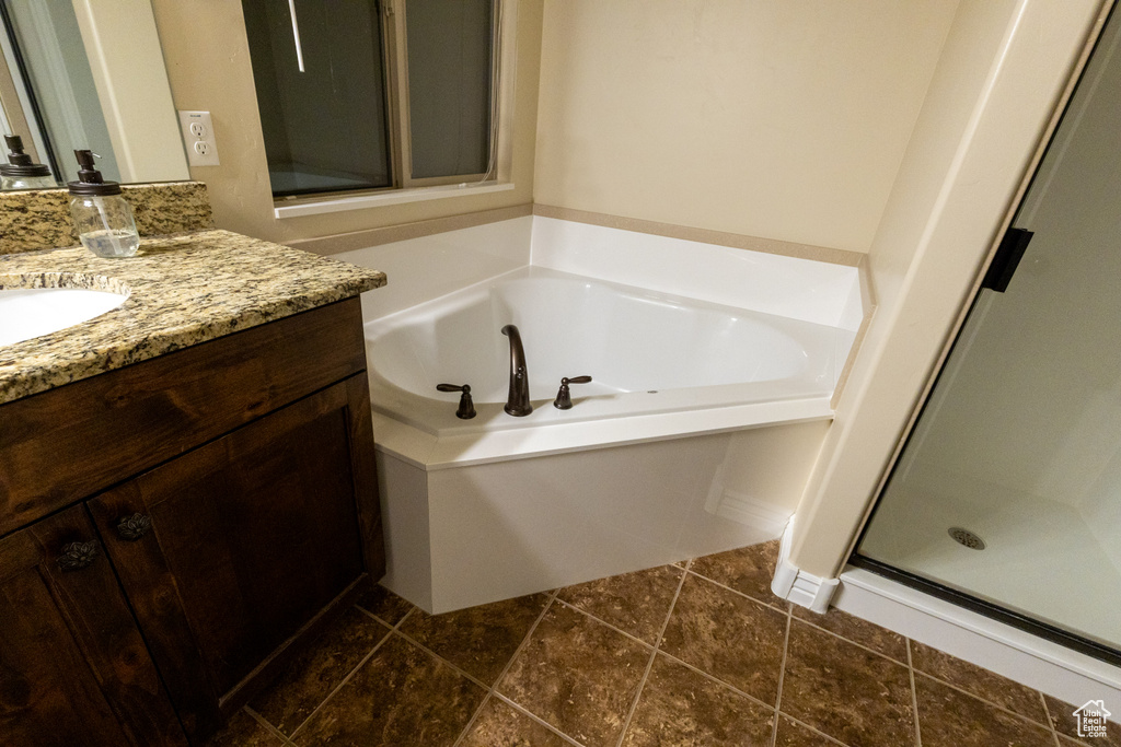 Bathroom with a shower stall, a garden tub, and vanity