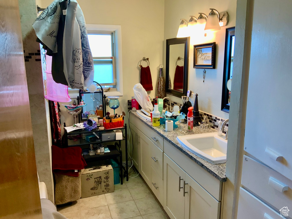 Bathroom featuring tile patterned flooring and vanity