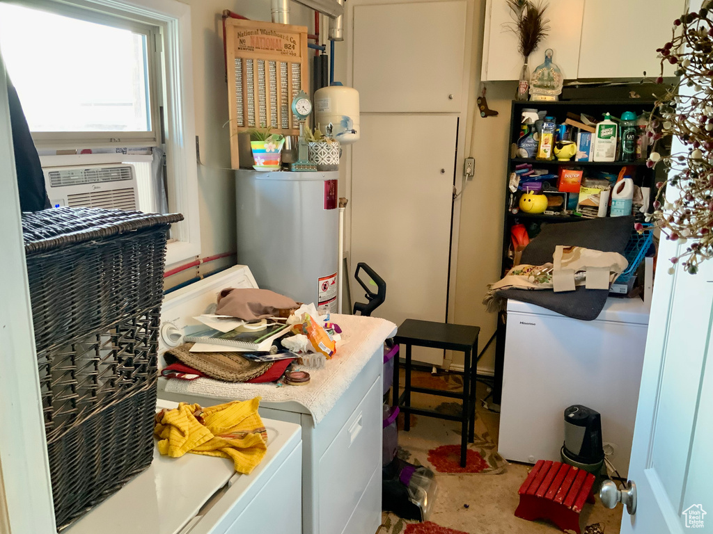Laundry room featuring water heater, washer and clothes dryer, and cooling unit