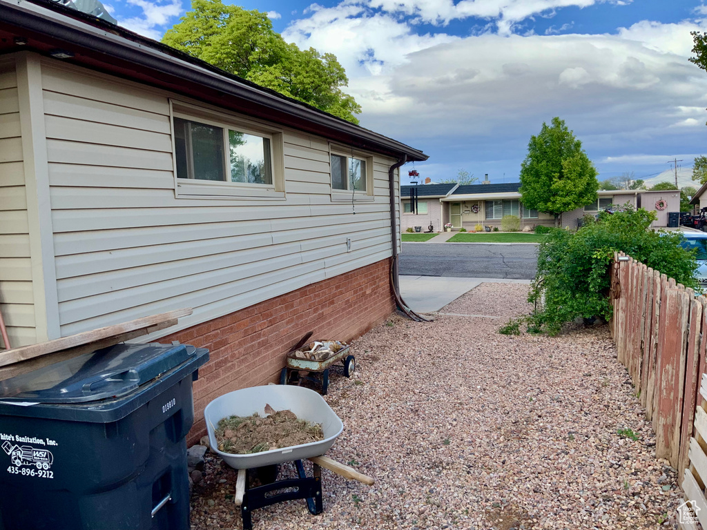 View of side of home with fence