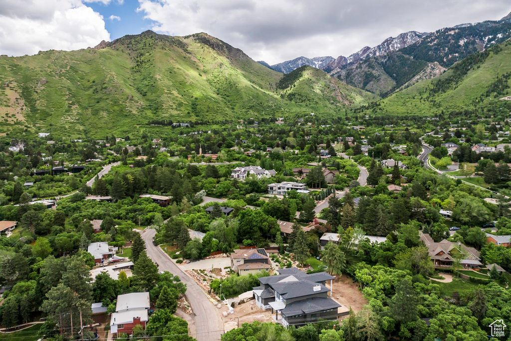 Aerial view of property and surrounding area with a mountain backdrop