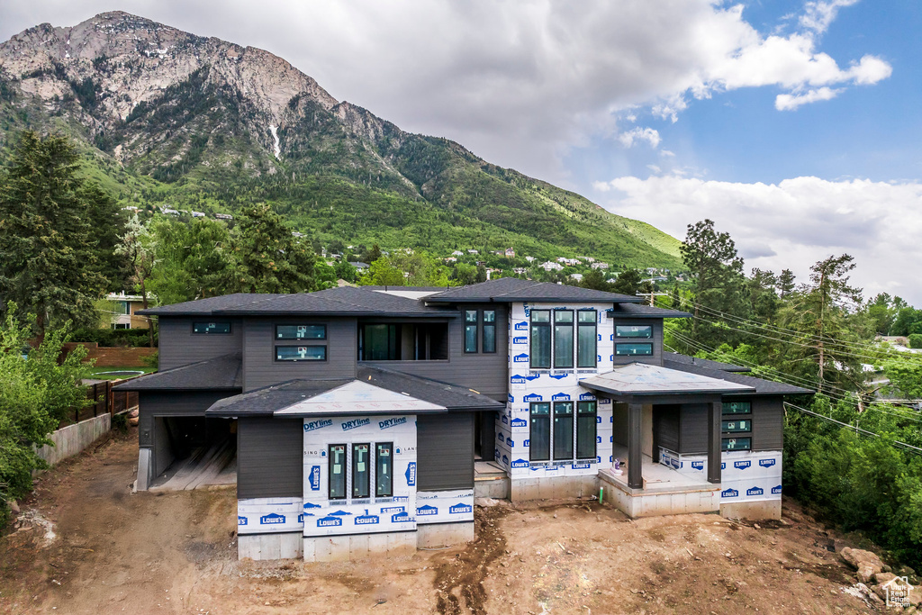 Back of property with a mountain view