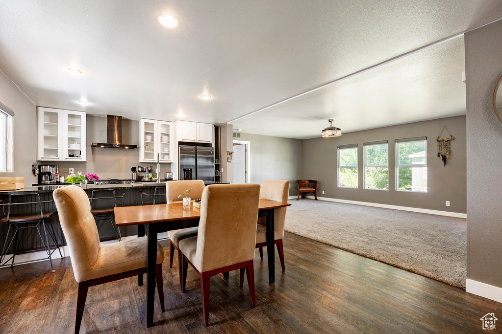 Dining room with baseboards, dark wood-style floors, and recessed lighting