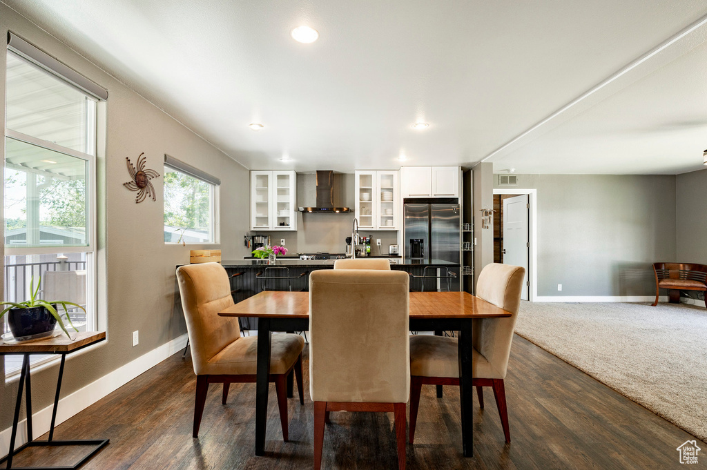 Dining space with baseboards, dark wood-style floors, and recessed lighting