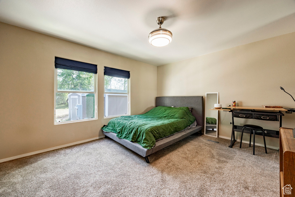 Carpeted bedroom featuring baseboards