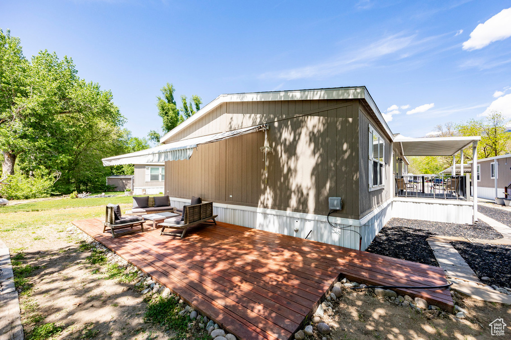 Rear view of property featuring outdoor lounge area and a wooden deck