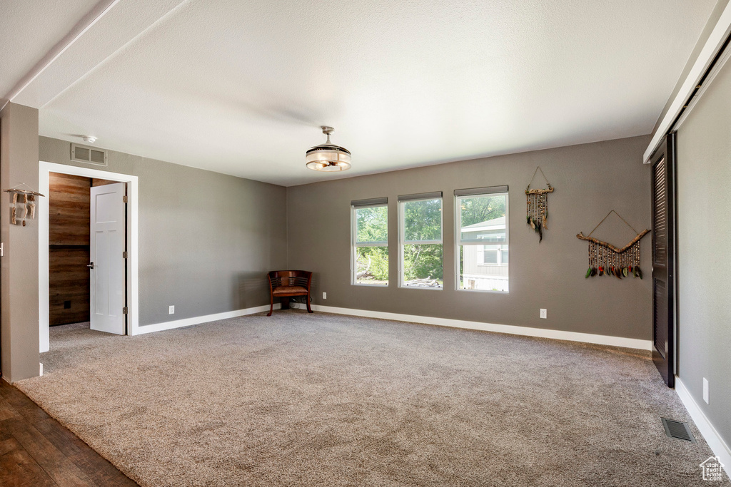 Carpeted empty room featuring baseboards