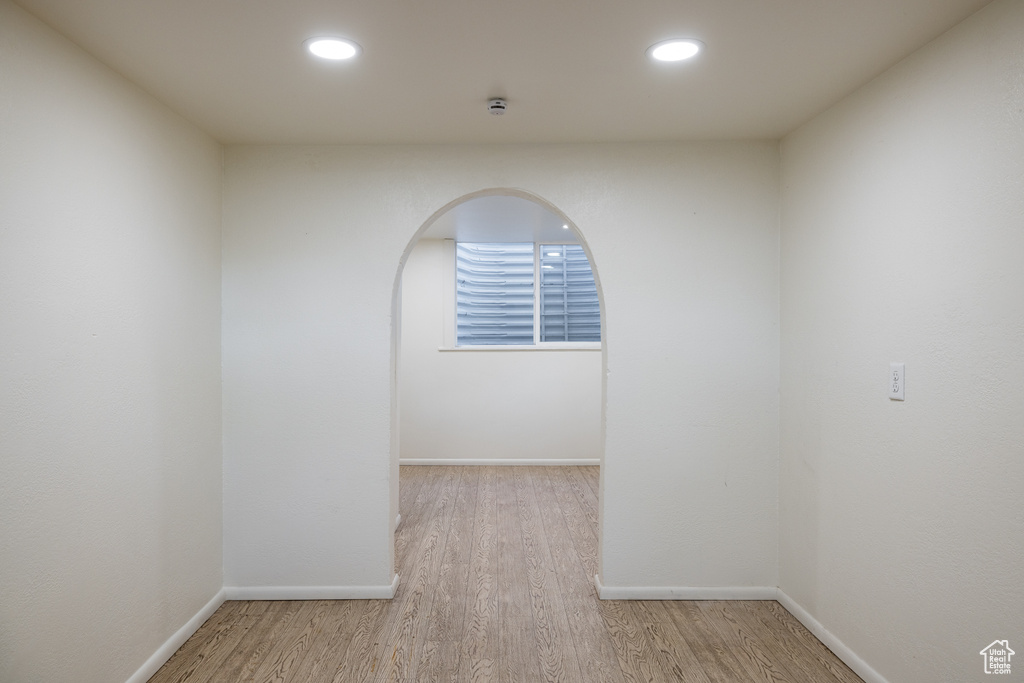 Spare room featuring wood finished floors, baseboards, recessed lighting, and a smoke detector